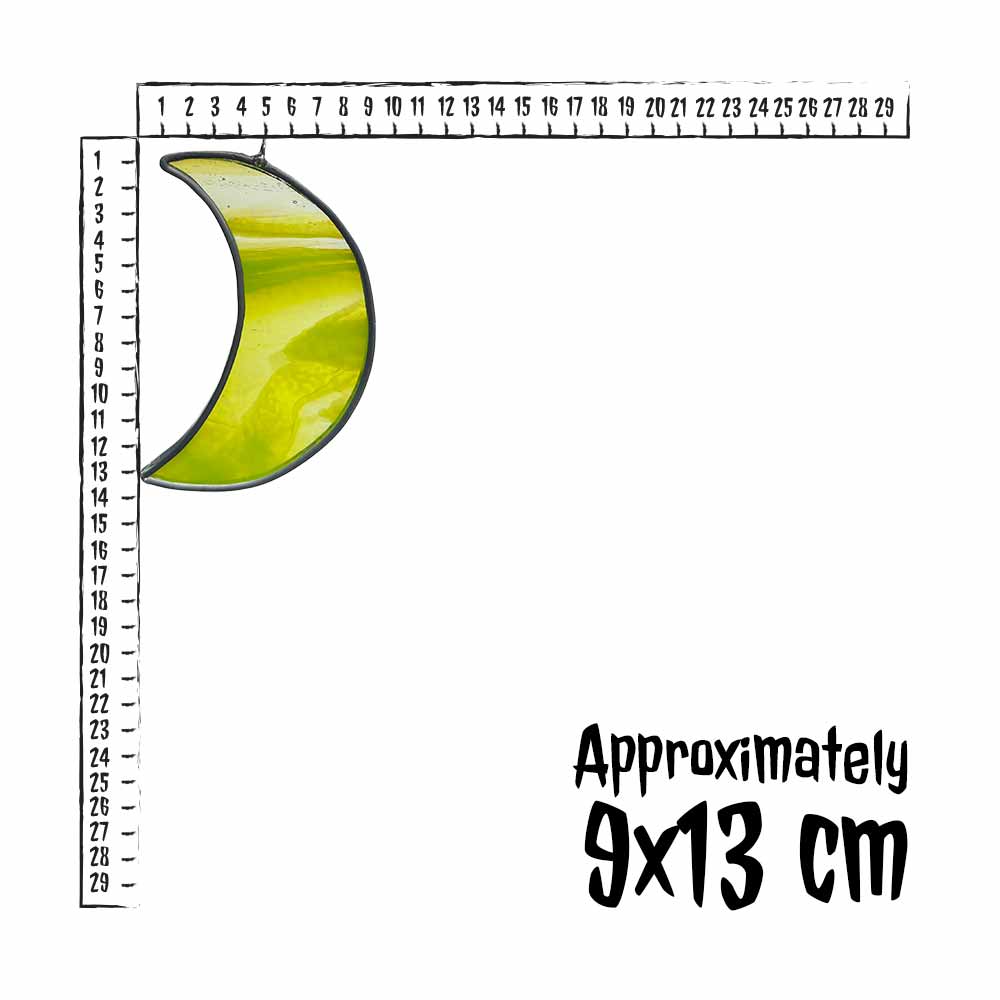 Neon yellow crescent moonstained glass piece with a ruler for scale on a white background
