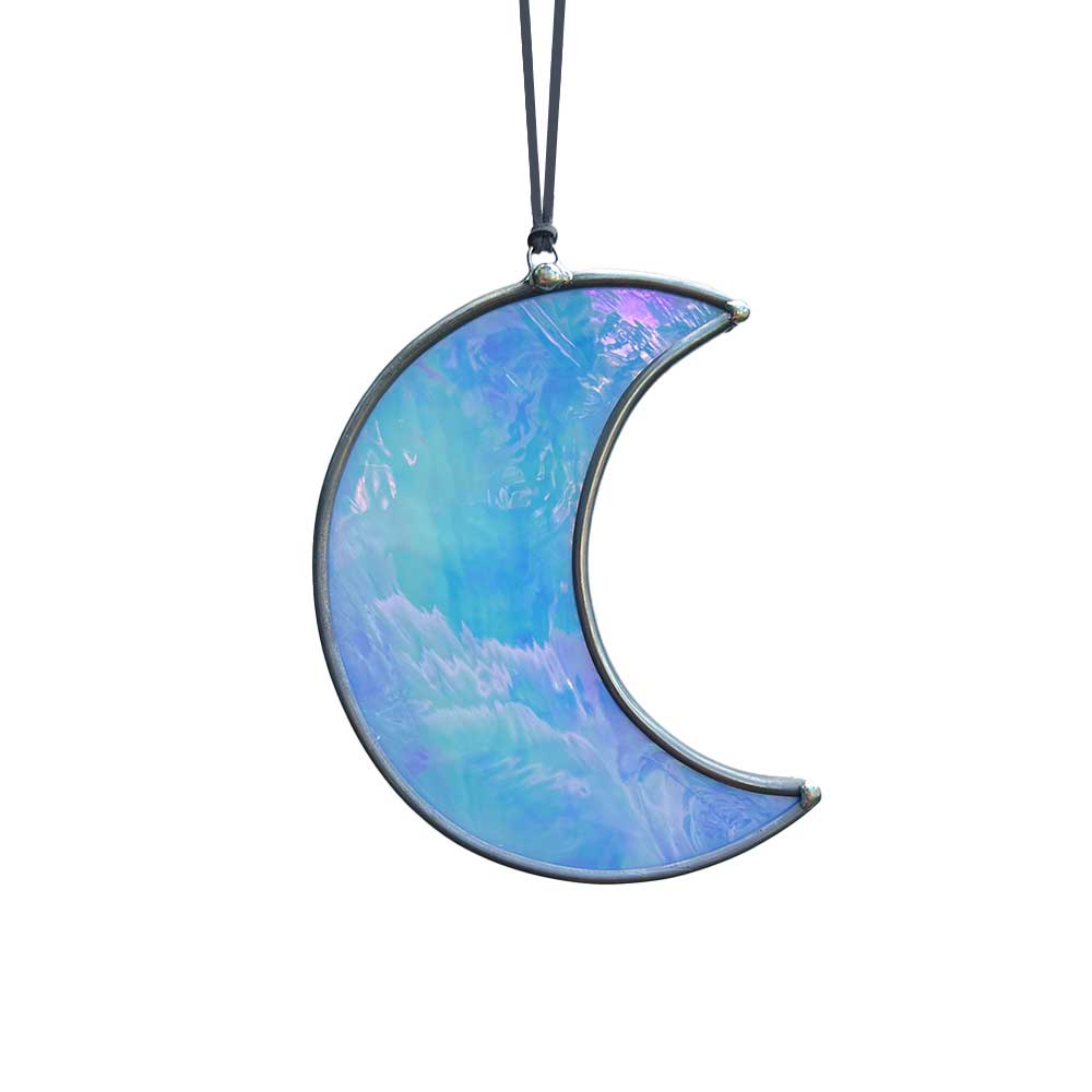 Iridescent blue crescent moon-shaped stained glass home decor piece on a white background