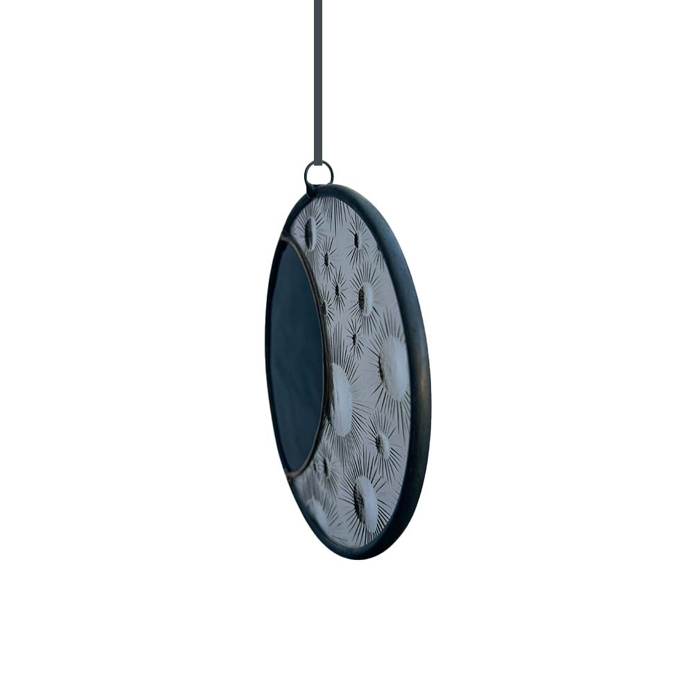 Decorative circular hanging Stained Glass piece with dark frame and crater pattern on a white background.
