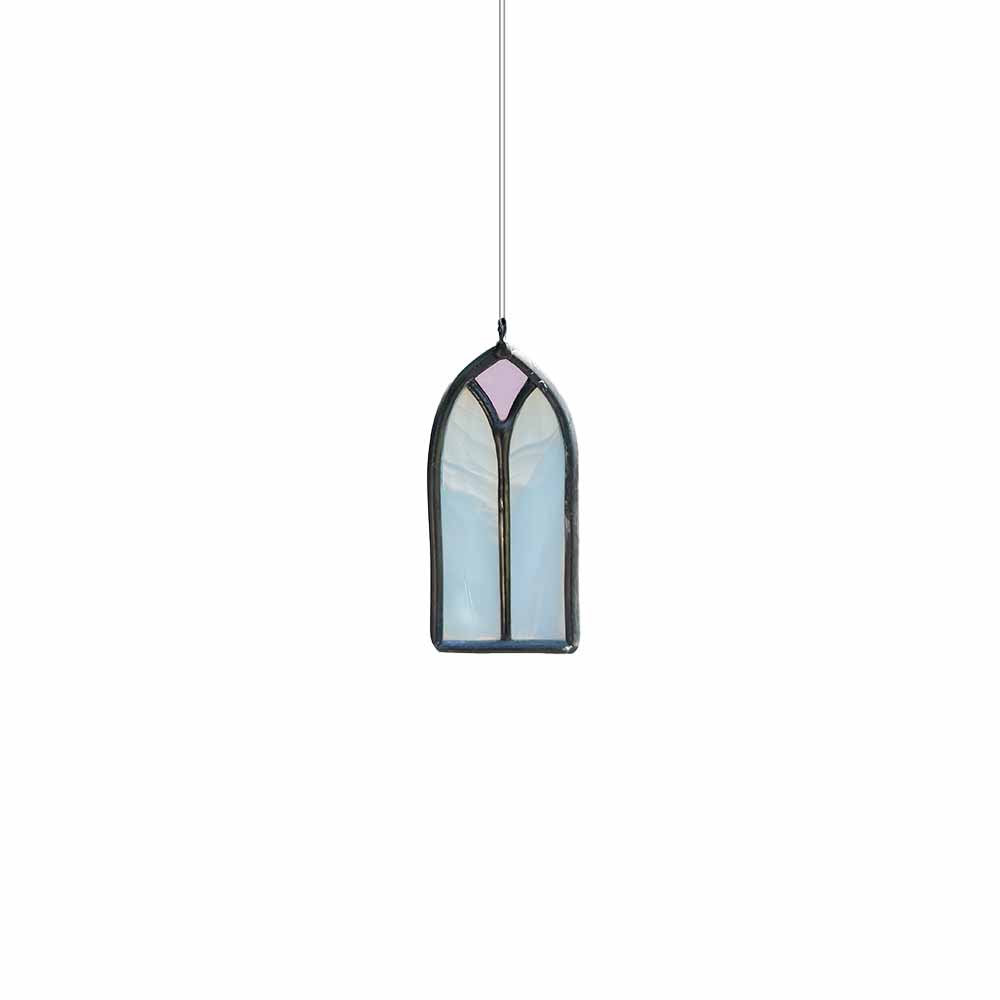 White and pink stained glass window hanging on a white background