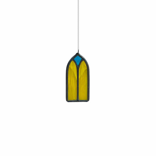 Yellow and teal stained glass window hanging on a white background
