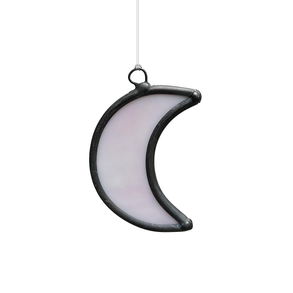 Soft pink stained glass moon decor piece, artisan-made to illuminate windows.