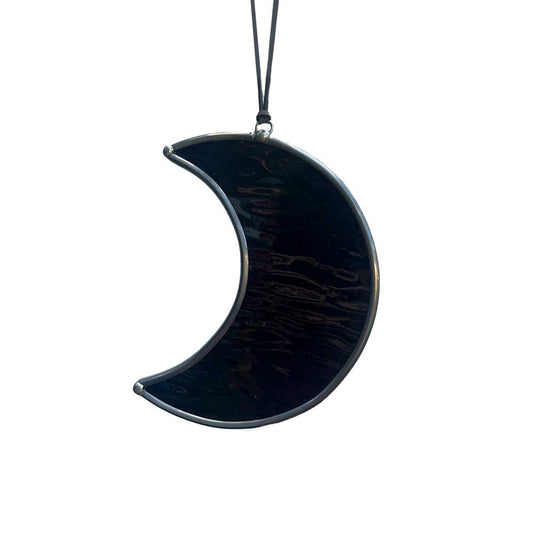Black crescent moon-shaped window decor on a white background