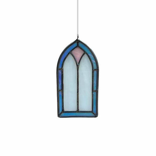 Iridescent stained glass window hanging on a white background