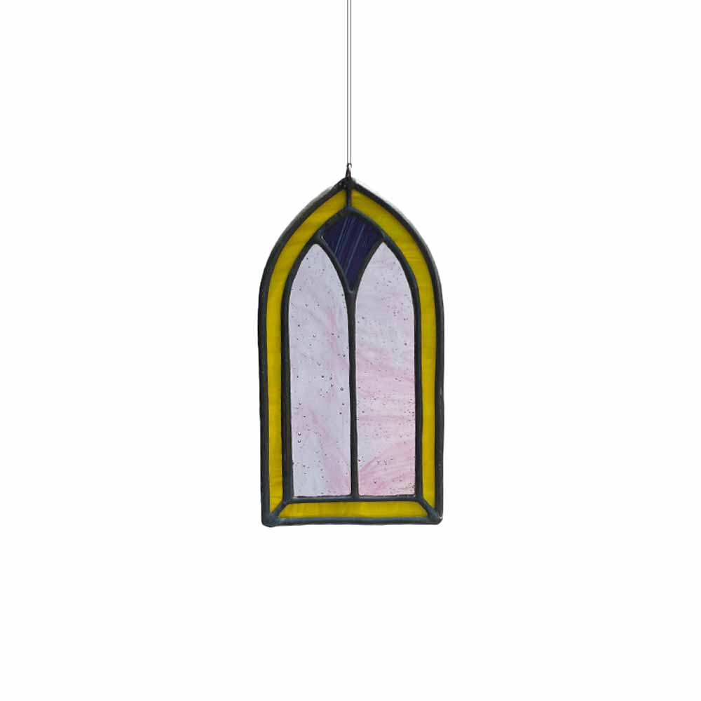 Yellow and purple stained glass window panel with a gothic arch design on a white background