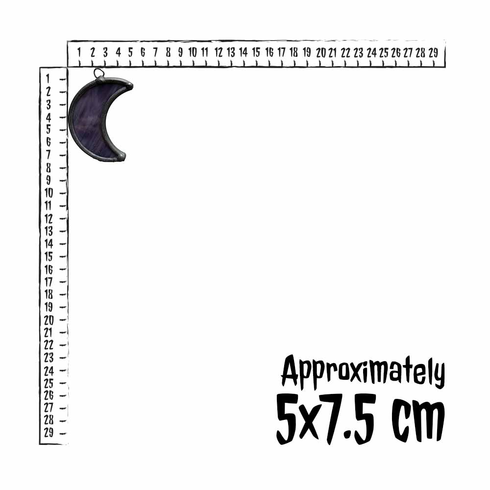 Deep purple stained glass moon next to a ruler for measurement.