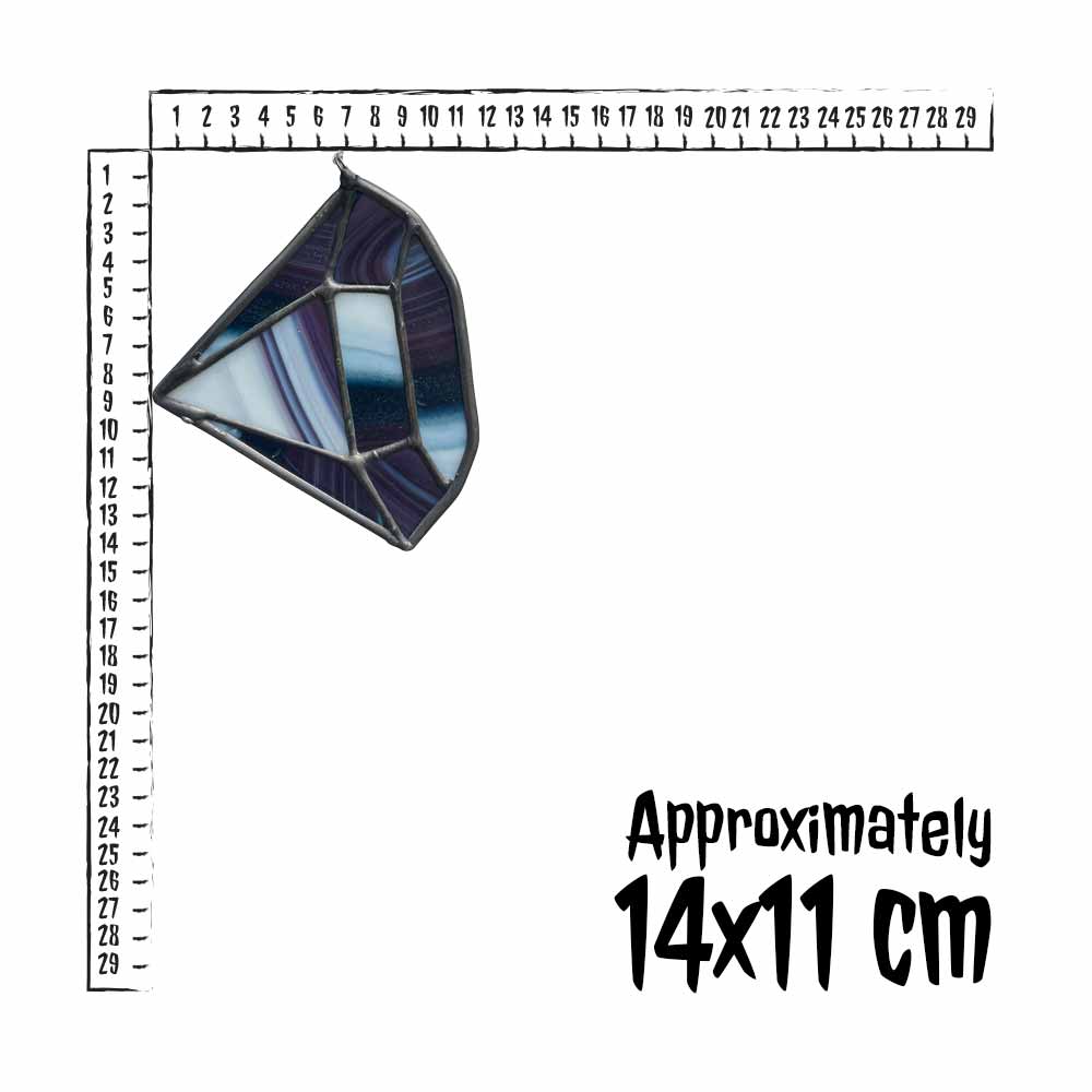Stained glass purple diamond with a ruler for scale on a white background