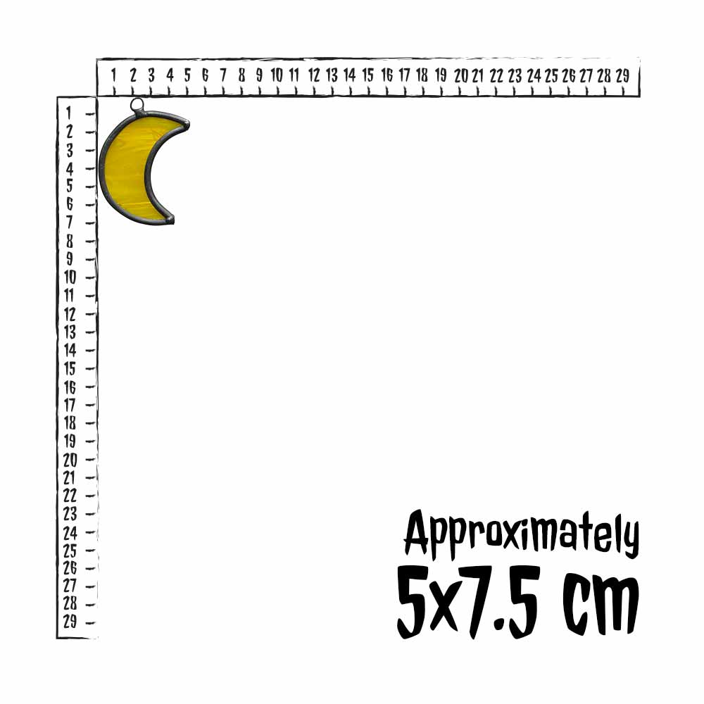 Small yellow stained glass crescent moon with a ruler indicating its approximate size on a white background.