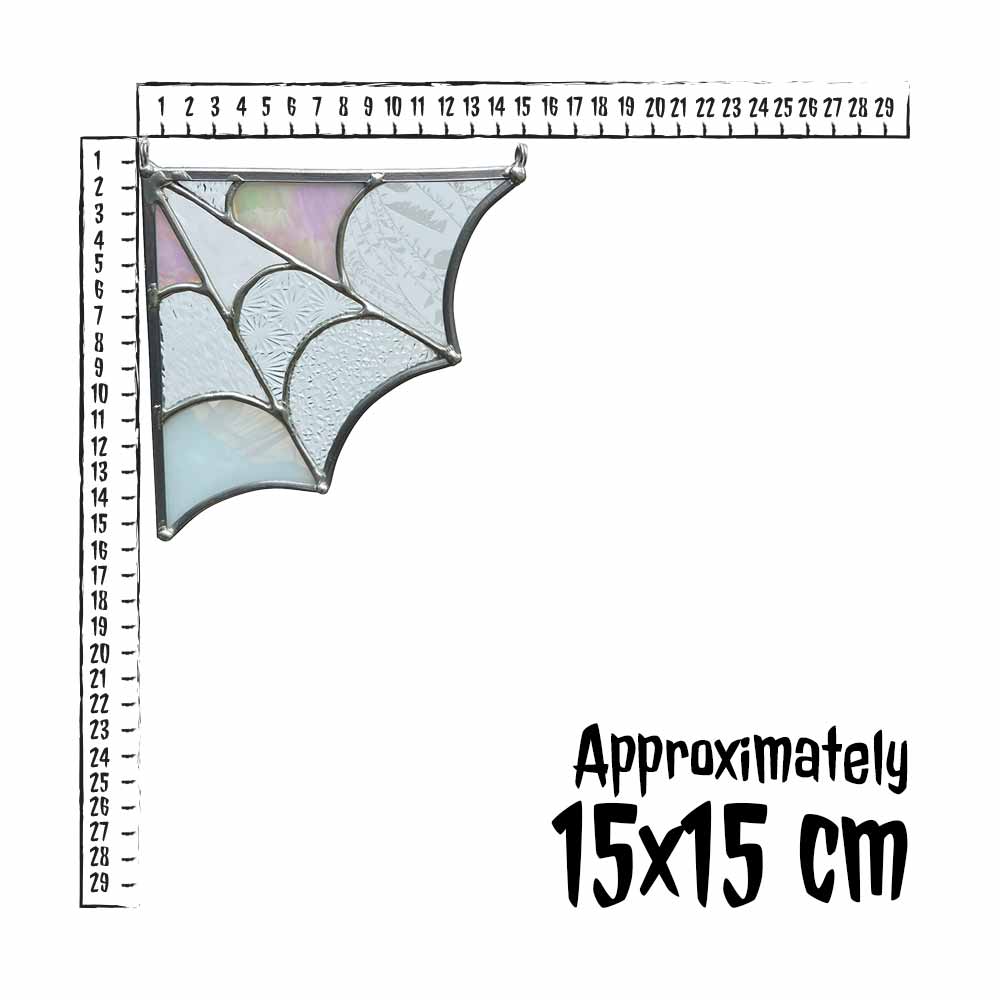 Stained glass spider web decor and measurement ruler on a white background