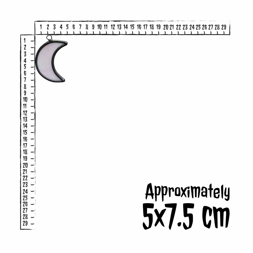 Small stained glass crescent moon charm next to on a ruler for scale, with text indicating size.