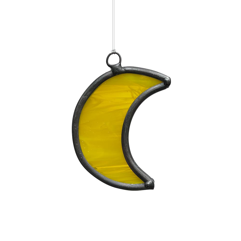 Bright yellow stained glass moon window decor, handcrafted to catch sunlight beautifully.